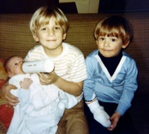 Dave Eaton family~ 1969, Tim feeding bottle to baby Kelly, Mark with sock on hand