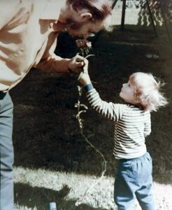 Dave Eaton family~ 1969c, Dave smelling flower that Mark picked