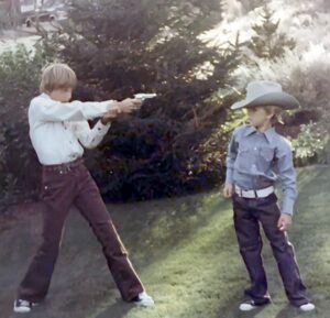 Dave Eaton family~ 1976, Bend, OR, Tim with cap gun pointed at Kelly