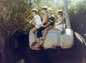 Dave Eaton family~ 1977c, San Diego Zoo, CA, Mark & Kelly riding elephant between boy & girl