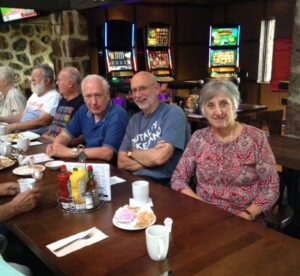 Eaton, Dave~ 2010s, at Brasserie le Manoir, 600 St-Jean Boulevard, Pointe, Claire, QC between wife Toni Nazair & Lloyd Coffin, Hank Sherrard in white t-shirt